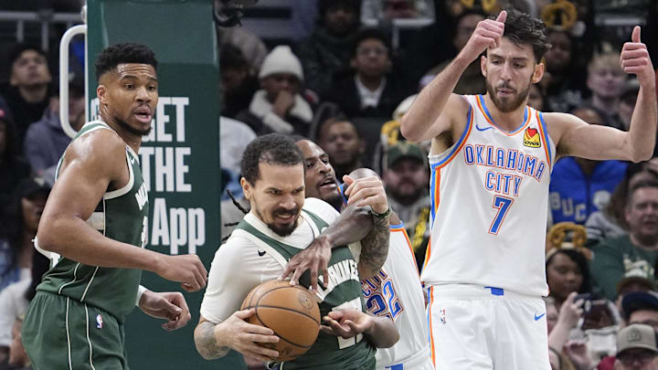 Jan 21, 2026; Milwaukee, Wisconsin, USA; Oklahoma City Thunder guard Cason Wallace (22) and Milwaukee Bucks guard Cole Anthony (50) battle for the ball in the first half at Fiserv Forum. Mandatory Credit: Michael McLoone-Imagn Images