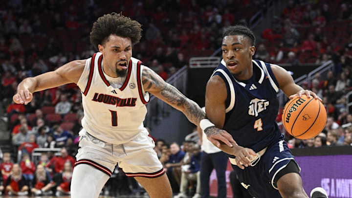 Dec 11, 2024; Louisville, Kentucky, USA;  UTEP Miners guard Corey Camper Jr. (4) dribbles against Louisville Cardinals guard J'Vonne Hadley (1) during the first half at KFC Yum! Center. Mandatory Credit: Jamie Rhodes-Imagn Images