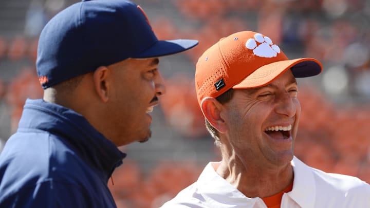 Oct 19, 2024; Clemson, South Carolina, USA; Virginia Cavaliers Head Coach Tony Elliott interacts with Clemson Tigers head coach Dabo Swinney prior to the game at Memorial Stadium. Mandatory Credit: Alexander Hicks-Imagn Images