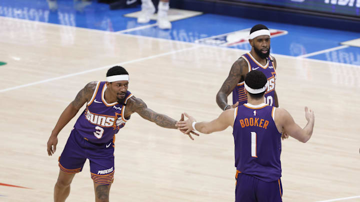 Feb 5, 2025; Oklahoma City, Oklahoma, USA; Phoenix Suns guard Bradley Beal (3) high fives guard Devin Booker (1) after a play against the Oklahoma City Thunder during the first half of a game at Paycom Center. Mandatory Credit: Alonzo Adams-Imagn Images