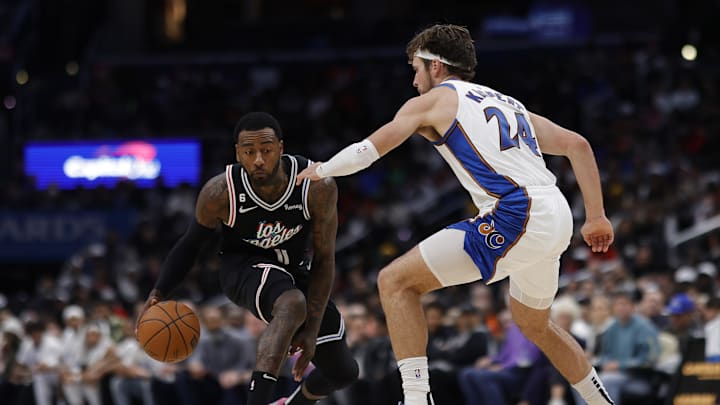 Dec 10, 2022; Washington, District of Columbia, USA; Los Angeles Clippers guard John Wall (11) dribbles the ball as Washington Wizards forward Corey Kispert (24) defends in the fourth quarter at Capital One Arena. Mandatory Credit: Geoff Burke-Imagn Images