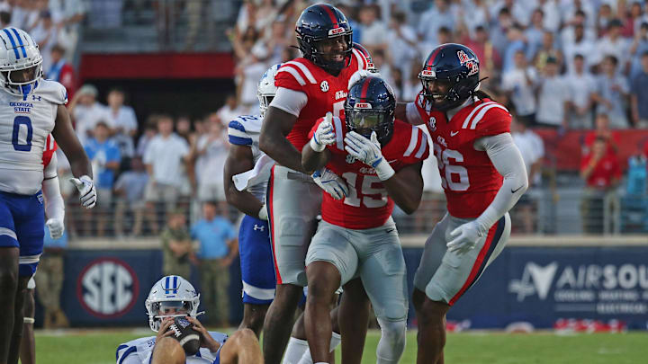 Aug 30, 2025; Oxford, Mississippi, USA; Mississippi Rebels defensive end Kam Franklin (5) and linebacker Tahj Chambers (26) react with defensive end Da'Shawn Womack (15) after sacking Georgia State Panthers quarterback Christian Veilleux (11) during the first quarter at Vaught-Hemingway Stadium. Mandatory Credit: Petre Thomas-Imagn Images