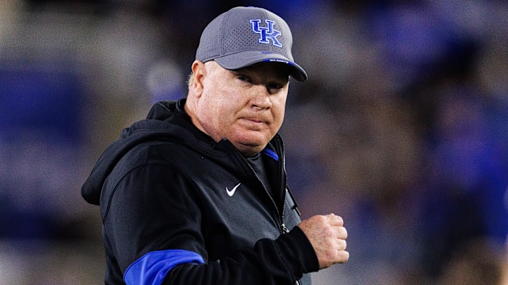 Oct 26, 2024; Lexington, Kentucky, USA; Kentucky Wildcats head coach Mark Stoops runs onto the field before the game against the Auburn Tigers at Kroger Field. Mandatory Credit: Jordan Prather-Imagn Images