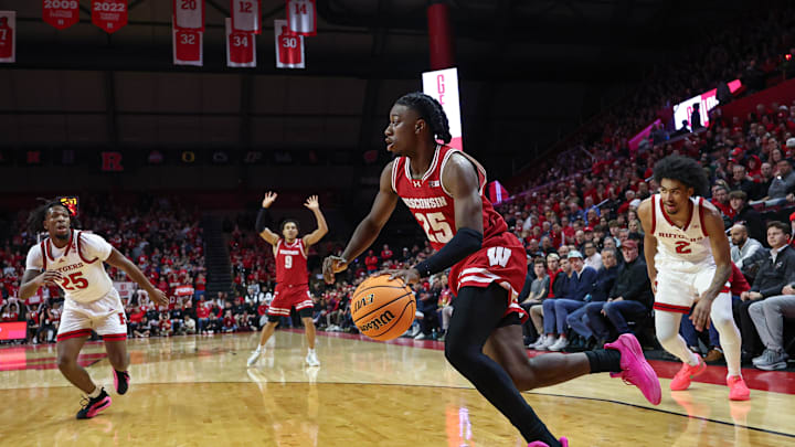 Jan 6, 2025; Piscataway, New Jersey, USA; Wisconsin Badgers guard John Blackwell (25) goes to the basket in front of Rutgers Scarlet Knights guard Dylan Harper (2) during the first half at Jersey Mike's Arena. 