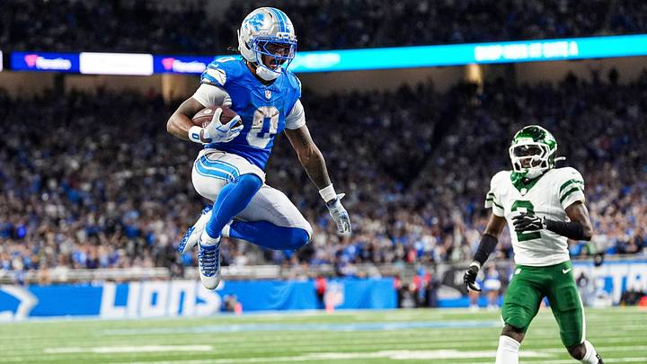 Detroit Lions running back Jahmyr Gibbs (0) leaps into the end zone for a touchdown against New York Jets during the second half at Ford Field in Detroit on Sunday, Sept. 27, 2026. Detroit Lions running back Jahmyr Gibbs (0) leaps into the end zone for a touchdown against New York Jets during the second half at Ford Field in Detroit on Sunday, Sept. 27, 2026.