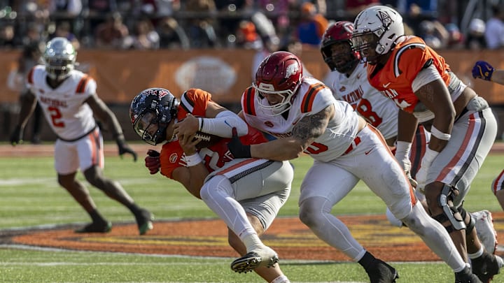 Feb 1, 2025; Mobile, AL, USA; National team defensive lineman Landon Jackson of Arkansas (40) hits American team quarterback Jaxson Dart of Ole Miss (2) during the first half of the 2025 Senior Bowl football game at Hancock Whitney Stadium. Mandatory Credit: Vasha Hunt-Imagn Images