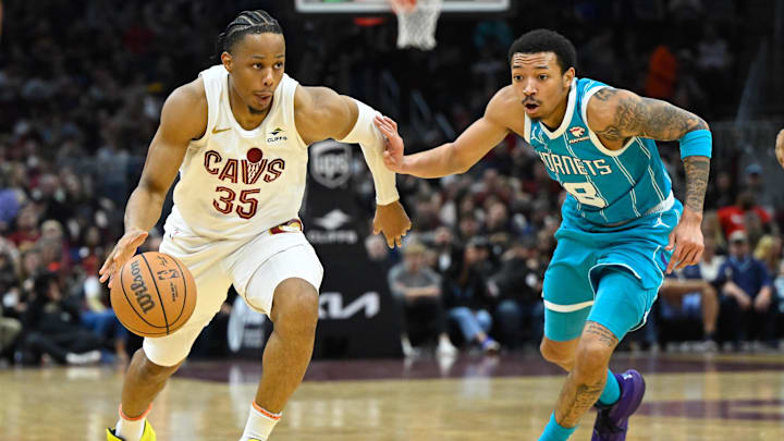 Apr 14, 2024; Cleveland, Ohio, USA; Cleveland Cavaliers forward Isaac Okoro (35) dribbles against Charlotte Hornets guard Nick Smith Jr. (8) in the second quarter at Rocket Mortgage FieldHouse. Mandatory Credit: David Richard-Imagn Images