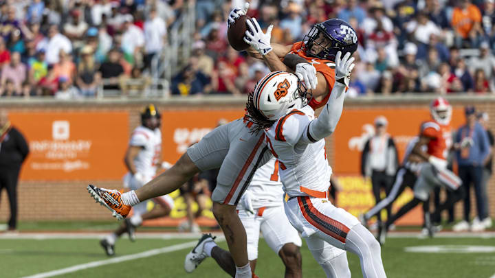 American team wide receiver Jack Bech of TCU (7) grabs a pass over National team safety Trey Rucker of Oklahoma State.