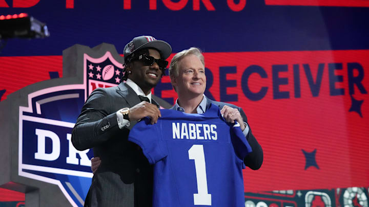 New York Giants WR Malik Nabers poses with NFL commissioner Roger Goodell following his selection as the sixth overall pick in the draft. New York Giants WR Malik Nabers poses with NFL commissioner Roger Goodell following his selection as the sixth overall pick in the draft.
