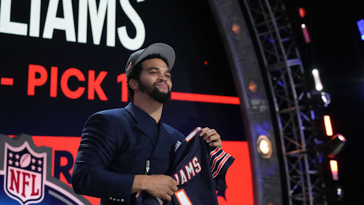 Apr 25, 2024; Detroit, MI, USA; Southern California Trojans quarterback Caleb Williams holds up his jersey at the draft - Kirby Lee/USA TODAY Sports