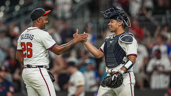 Aug 7, 2025; Cumberland, Georgia, USA; Atlanta Braves relief pitcher Raisel Iglesias (26) reacts with catcher Drake Baldwin (30) after the Braves defeated the Miami Marlins at Truist Park. Mandatory Credit: Dale Zanine-Imagn Images