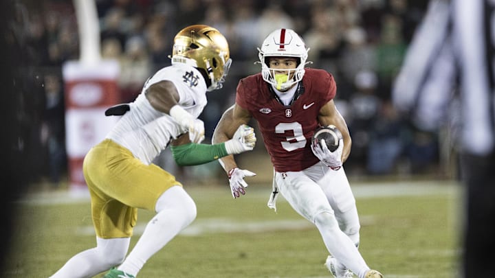 Nov 29, 2025; Stanford, California, USA;  Stanford Cardinal wide receiver CJ Williams (3) runs with the football during the second quarter against Notre Dame Fighting Irish linebacker Jaylen Sneed (3) at Stanford Stadium. Mandatory Credit: Stan Szeto-Imagn Images