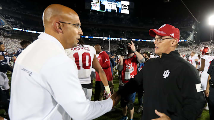Former Indiana football coach Tom Allen (right) shakes hands with Penn State coach James Franklin (left) after a game at Beaver Stadium in 2021.