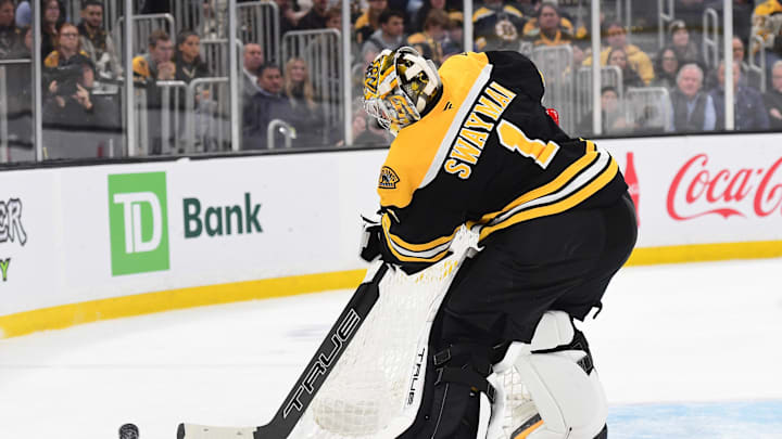 Nov 18, 2024; Boston, Massachusetts, USA;  Boston Bruins goaltender Jeremy Swayman (1) clears the puck around the goal during the second period against the Columbus Blue Jackets at TD Garden. Mandatory Credit: Bob DeChiara-Imagn Images