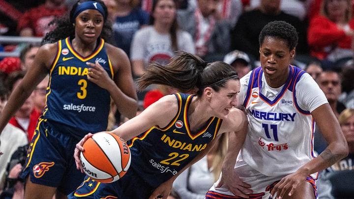 Jun 22, 2026; Indianapolis, Indiana, USA;  Indiana Fever guard Caitlin Clark (22) dribbles  the ball while Phoenix Mercury forward Valeriane Ayayi (11) defends in the first half at Gainbridge Fieldhouse. Mandatory Credit: Trevor Ruszkowski-Imagn Images