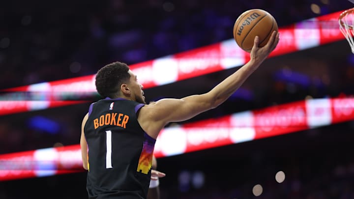 Jan 20, 2026; Philadelphia, Pennsylvania, USA; Phoenix Suns guard Devin Booker (1) drives for a shot against the Philadelphia 76ers during the first quarter at Xfinity Mobile Arena. Mandatory Credit: Bill Streicher-Imagn Images