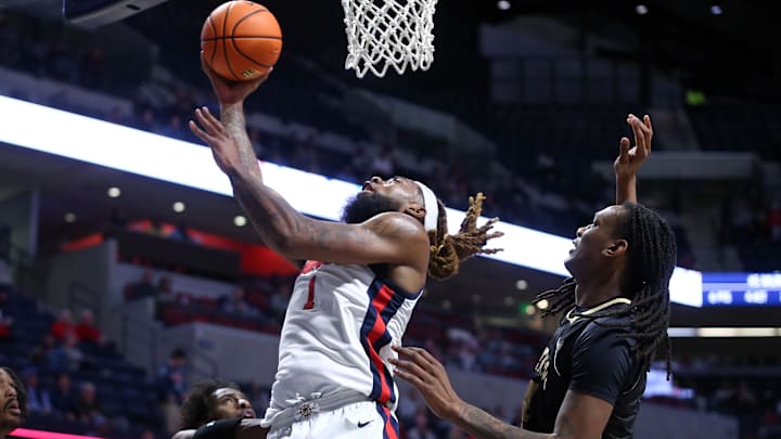 Dec 7, 2024; Oxford, Mississippi, USA; Mississippi Rebels forward Mikeal Brown-Jones (1) shoots the ball against Lindenwood Lions forward Jordan Wildy (4) during the second half at The Sandy and John Black Pavilion at Ole Miss. Mandatory Credit: Petre Thomas-Imagn Images Dec 7, 2024; Oxford, Mississippi, USA; Mississippi Rebels forward Mikeal Brown-Jones (1) shoots the ball against Lindenwood Lions forward Jordan Wildy (4) during the second half at The Sandy and John Black Pavilion at Ole Miss. Mandatory Credit: Petre Thomas-Imagn Images