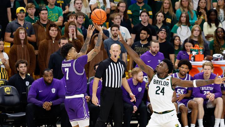 Nov 14, 2025; Waco, Texas, USA;  Tarleton State Texans guard Dior Johnson (7) scores a three-point basket against Baylor Bears guard Tounde Yessoufou (24) during the second half at Paul and Alejandra Foster Pavilion. Mandatory Credit: Chris Jones-Imagn Images