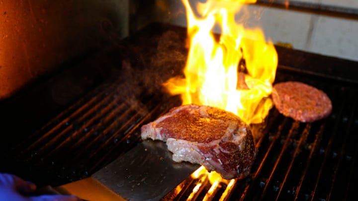 Centerfold cook Robert Baker flips a 1 pound ribeye steak on the grill on Wednesday, May 31, 2023.