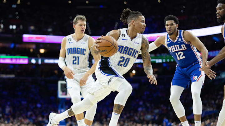 Jan 30, 2023; Philadelphia, Pennsylvania, USA; Orlando Magic guard Markelle Fultz (20) dribbles the ball in front of center Moritz Wagner (21) and Philadelphia 76ers forward Tobias Harris (12) during the first quarter at Wells Fargo Center. Mandatory Credit: Bill Streicher-Imagn Images