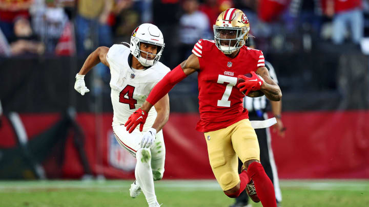 Dec 17, 2023; Glendale, Arizona, USA; San Francisco 49ers cornerback Charvarius Ward (7) runs the ball after an interception against Arizona Cardinals wide receiver Rondale Moore (4) at State Farm Stadium. Mandatory Credit: Mark J. Rebilas-USA TODAY Sports