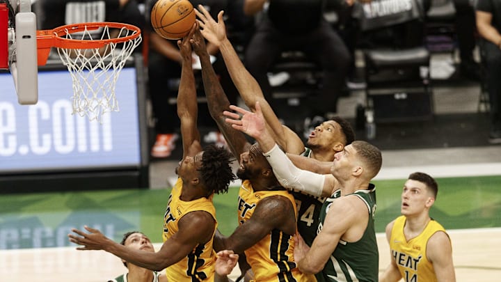 May 22, 2021; Milwaukee, Wisconsin, USA;  Miami Heat guard Jimmy Butler (22), Miami Heat center Dewayne Dedmon (21), Milwaukee Bucks forward Giannis Antetokounmpo (34) and center Brook Lopez (11) reach for a rebound during the second quarter during game one in the first round of the 2021 NBA Playoffs. at Fiserv Forum. Mandatory Credit: Jeff Hanisch-Imagn Images