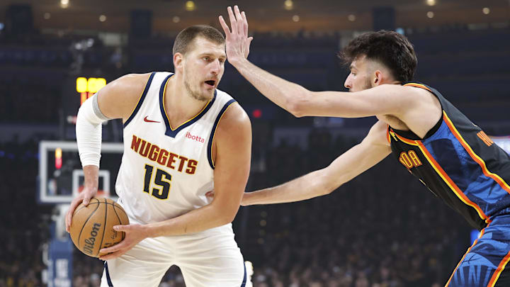 May 5, 2025; Oklahoma City, Oklahoma, USA; Denver Nuggets center Nikola Jokic (15) is defended by Oklahoma City Thunder forward Chet Holmgren (7) during the first quarter during game one of the second round for the 2025 NBA Playoffs at Paycom Center. Mandatory Credit: Alonzo Adams-Imagn Images