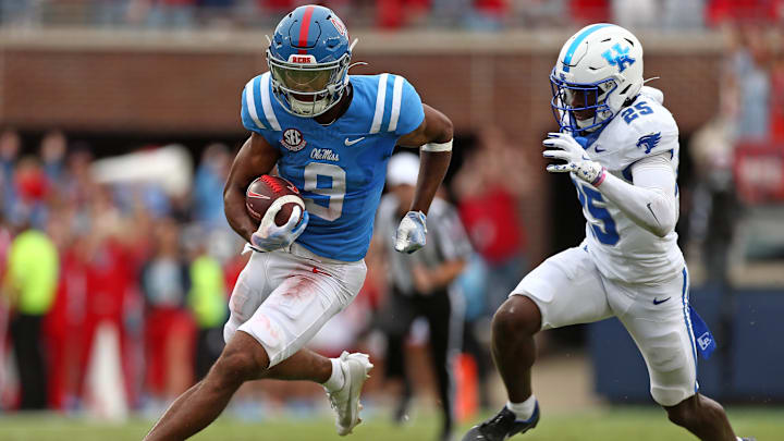 Sep 28, 2024; Oxford, Mississippi, USA; Mississippi Rebels wide receiver Tre Harris (9) runs after a catch as Kentucky Wildcats defensive back Jordan Lovett (25) pursues during the second half at Vaught-Hemingway Stadium. Mandatory Credit: Petre Thomas-Imagn Images