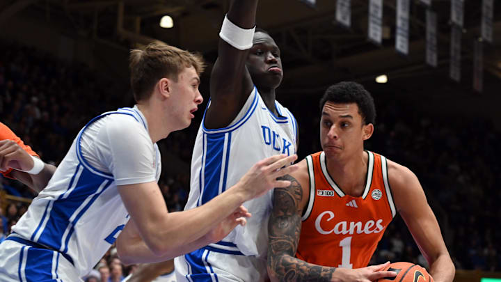 Jan 14, 2025; Durham, North Carolina, USA; Miami Hurricanes center Lynn Kidd (1) looks to shoot as Duke Blue Devils forward Cooper Flagg (2) and Duke Blue Devils center Khaman Maluach (9) defend during the first half at Cameron Indoor Stadium. Mandatory Credit: Rob Kinnan-Imagn Images