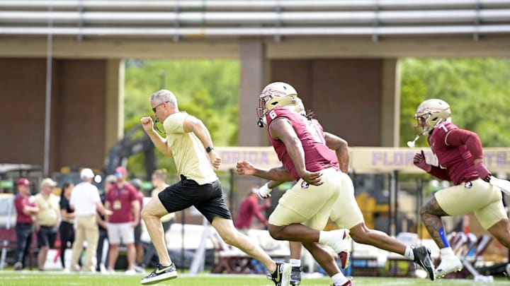 Apr 20, 2024; Tallahassee, Florida, USA; Florida State Seminoles head coach Mike Norvell races some of his players to the other end of the field during the Spring Showcase at Doak S. Campbell Stadium. Mandatory Credit: Melina Myers-USA TODAY Sports