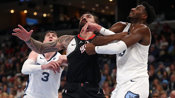 Jan 9, 2025; Memphis, Tennessee, USA; Houston Rockets center Steven Adams (12) and Memphis Grizzlies forward Jaren Jackson Jr. (13) battle for position during the fourth quarter at FedExForum. Mandatory Credit: Petre Thomas-Imagn Images