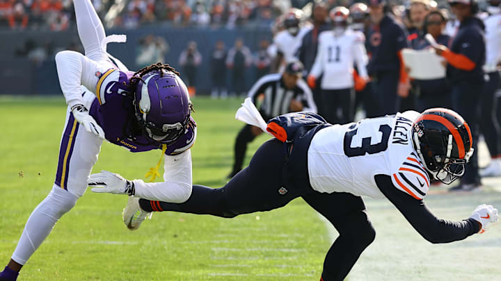 Nov 24, 2024; Chicago, Illinois, USA; Chicago Bears wide receiver Keenan Allen (13) makes a catch over Minnesota Vikings cornerback Shaquill Griffin (1) and after replay is ruled out of bounds on his left foot touching the line during the second quarter at Soldier Field. Mandatory Credit: Mike Dinovo-Imagn Images