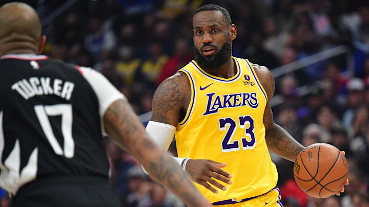 Los Angeles Lakers forward LeBron James (23) moves the ball against Los Angeles Clippers forward P.J. Tucker (17) during the first half at Crypto.com Arena. Mandatory Credit: Gary A. Vasquez-Imagn Images