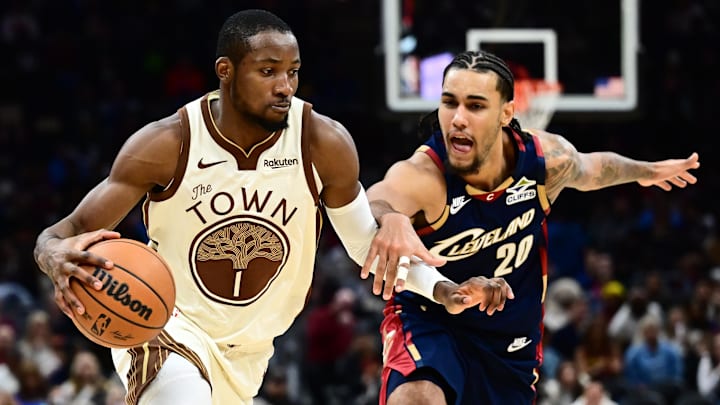 Dec 6, 2025; Cleveland, Ohio, USA; Golden State Warriors forward Jonathan Kuminga (1) drives to the basket against Cleveland Cavaliers guard Jaylon Tyson (20) during the second half at Rocket Arena. Mandatory Credit: Ken Blaze-Imagn Images
