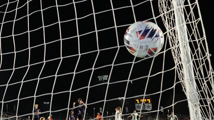 Dec 12, 2025; Cary, NC, USA; Washington Huskies midfielder Zach Ramsey (6) scores a goal as Furman Paladins goalkeeper Ivan Horvat (30) defends in the first half at First Horizon Stadium. Mandatory Credit: Bob Donnan-Imagn Images Dec 12, 2025; Cary, NC, USA; Washington Huskies midfielder Zach Ramsey (6) scores a goal as Furman Paladins goalkeeper Ivan Horvat (30) defends in the first half at First Horizon Stadium. Mandatory Credit: Bob Donnan-Imagn Images
