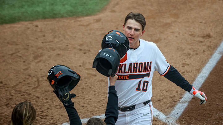 Oklahoma State outfielder Nolan Schubart (10) crosses home after hitting a home run during a college Oklahoma State outfielder Nolan Schubart (10) crosses home after hitting a home run during a college