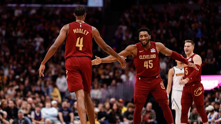 Dec 27, 2024; Denver, Colorado, USA; Cleveland Cavaliers guard Donovan Mitchell (45) reacts with forward Evan Mobley (4) after a play in the fourth quarter against the Denver Nuggets at Ball Arena. Mandatory Credit: Isaiah J. Downing-Imagn Images