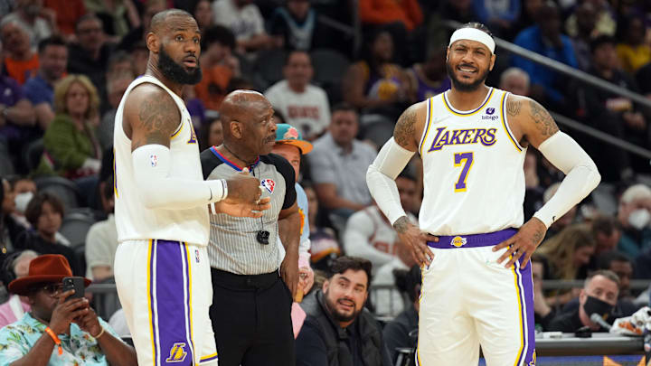 Mar 13, 2022; Phoenix, Arizona, USA; Los Angeles Lakers forward LeBron James (6) and forward Carmelo Anthony (7) argue a call with an official during the first half of the game against the Phoenix Suns at Footprint Center. Mandatory Credit: Joe Camporeale-Imagn Images