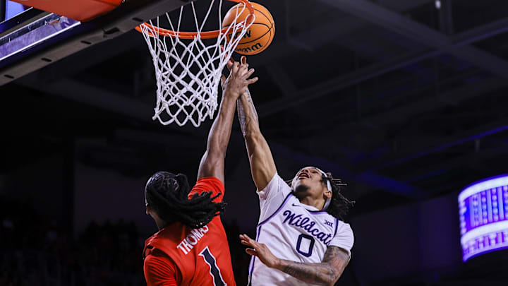 Mar 5, 2025; Cincinnati, Ohio, USA; Kansas State Wildcats guard Dug McDaniel (0) shoots against Cincinnati Bearcats guard Day Day Thomas (1) in the second half at Fifth Third Arena. Mandatory Credit: Katie Stratman-Imagn Images