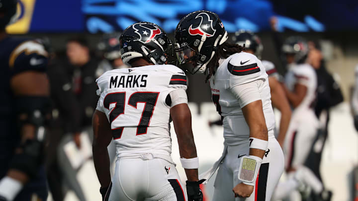 Dec 27, 2025; Inglewood, California, USA;  Houston Texans quarterback C.J. Stroud (7) celebrates with running back Woody Marks (27) after throwing a touchdown pass against the Los Angeles Chargers] during the first half at SoFi Stadium. Mandatory Credit: Kiyoshi Mio-Imagn Images