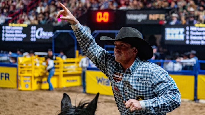 Tucker Allen taking his victory lap after splitting round four with Will Lummus at the NFR Tucker Allen taking his victory lap after splitting round four with Will Lummus at the NFR
