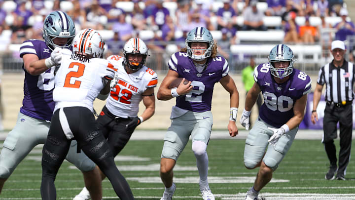 Sep 28, 2024; Manhattan, Kansas, USA; Kansas State Wildcats quarterback Avery Johnson (2) runs the ball against Oklahoma State Cowboys cornerback Korie Black (2) during the fourth quarter at Bill Snyder Family Football Stadium. Mandatory Credit: Scott Sewell-Imagn Images