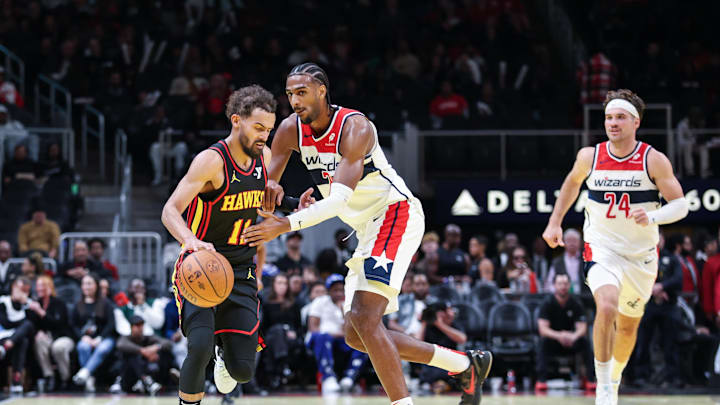 Nov 15, 2024; Atlanta, Georgia, USA; Washington Wizards forward Alexandre Sarr (20) fouls against Atlanta Hawks guard Trae Young (11) during the fourth quarter at State Farm Arena. Mandatory Credit: Jordan Godfree-Imagn Images
