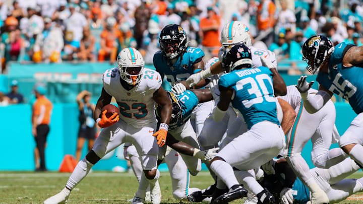 Sep 8, 2024; Miami Gardens, Florida, USA; Miami Dolphins running back Jeff Wilson Jr. (23) runs with the football against the Jacksonville Jaguars during the fourth quarter at Hard Rock Stadium. Mandatory Credit: Sam Navarro-Imagn Images
