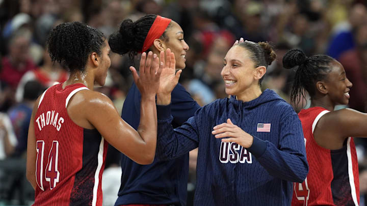 Aug 4, 2024; Villeneuve-d'Ascq, France; United States power forward Alyssa Thomas (14) and shooting guard Diana Taurasi (12) celebrate after defeating Germany in a women’s group C game during the Paris 2024 Olympic Summer Games at Stade Pierre-Mauroy. Mandatory Credit: John David Mercer-Imagn Images Aug 4, 2024; Villeneuve-d'Ascq, France; United States power forward Alyssa Thomas (14) and shooting guard Diana Taurasi (12) celebrate after defeating Germany in a women’s group C game during the Paris 2024 Olympic Summer Games at Stade Pierre-Mauroy. Mandatory Credit: John David Mercer-Imagn Images