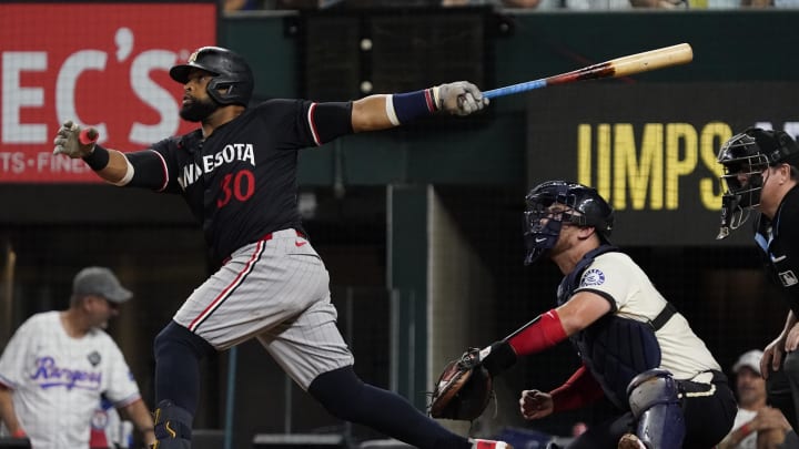 Minnesota Twins first baseman Carlos Santana (30) follows through on a three-run home run during the fifth inning against the Texas Rangers at Globe Life Field in Arlington, Texas, on Aug. 16, 2024. Minnesota Twins first baseman Carlos Santana (30) follows through on a three-run home run during the fifth inning against the Texas Rangers at Globe Life Field in Arlington, Texas, on Aug. 16, 2024.