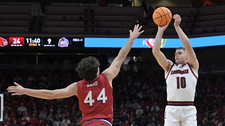 Nov 26, 2025; Louisville, Kentucky, USA;  Louisville Cardinals guard Isaac McKneely (10) shoots against NJIT Highlanders guard Rocco Awad (44) during the first half at KFC Yum! Center. Mandatory Credit: Jamie Rhodes-Imagn Images