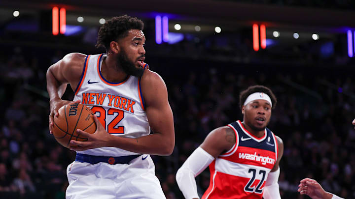 Oct 9, 2024; New York, New York, USA; New York Knicks center Karl-Anthony Towns (32) rebounds against Washington Wizards forward Richaun Holmes (22) during the first quarter at Madison Square Garden. Mandatory Credit: Vincent Carchietta-Imagn Images