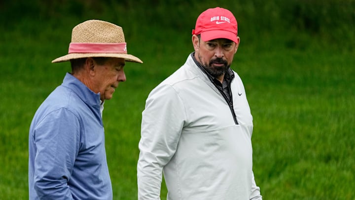 Ohio State football head coach Ryan Day talks to former Alabama football head coach Nick Saban as they walk along 14 during the Workday Golden Bear Pro-Am at Muirfield Village Golf Club in Dublin, Ohio on May 28, 2025.