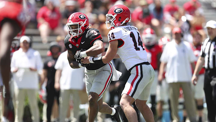 Apr 13, 2024; Athens, GA, USA; Georgia Bulldogs quarterback Gunner Stockton (14) hands the ball to running back Andrew Paul (3) during the G-Day Game at Sanford Stadium. Mandatory Credit: Mady Mertens-Imagn Images